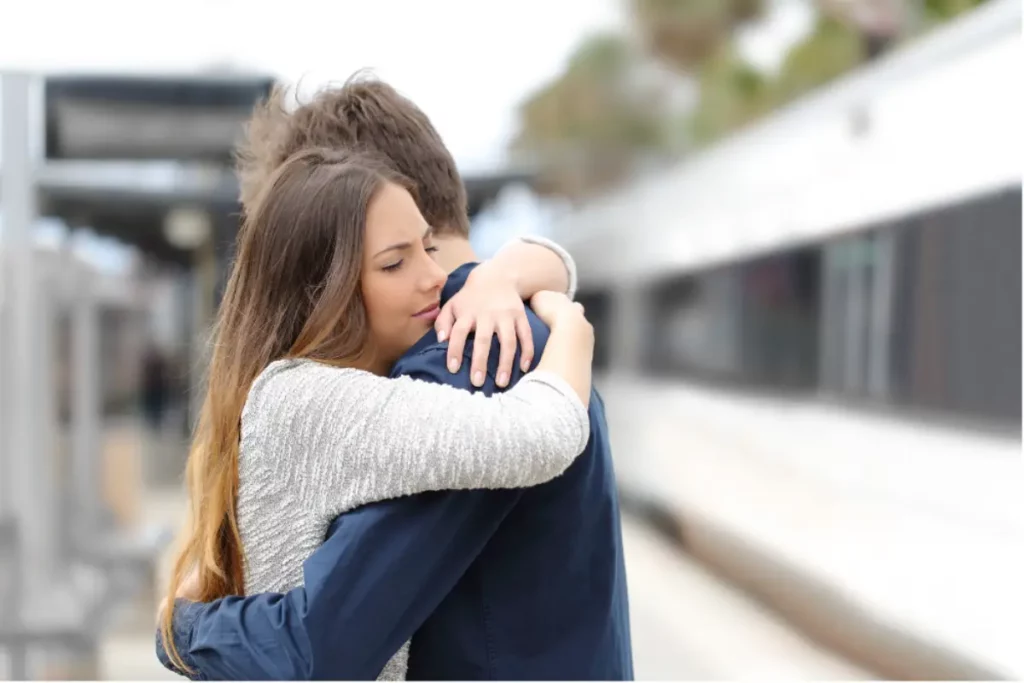 Couple hugging while traveling together with personalized travel concierge support for treatment