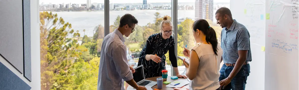 Group of adults collaborating in a meeting, representing community support and life skills in sober living.