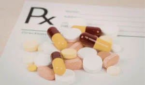 Prescription pills on a medical prescription pad representing dependence among high-performing professionals